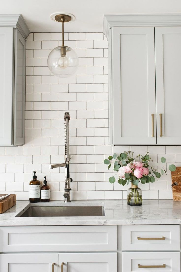 Light Gray Subway Tile Kitchen
 Light grey cabinets with brass gold hardware cabinet pulls