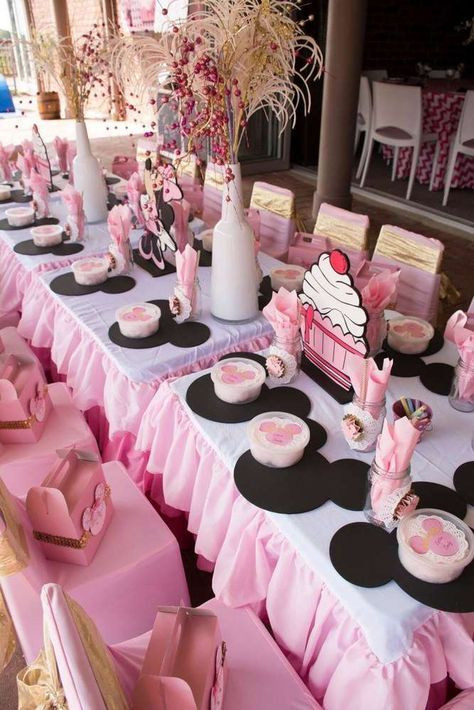 Minnie Mouse Birthday Decorations Pink
 Pink and black table at a Minnie Mouse birthday party See
