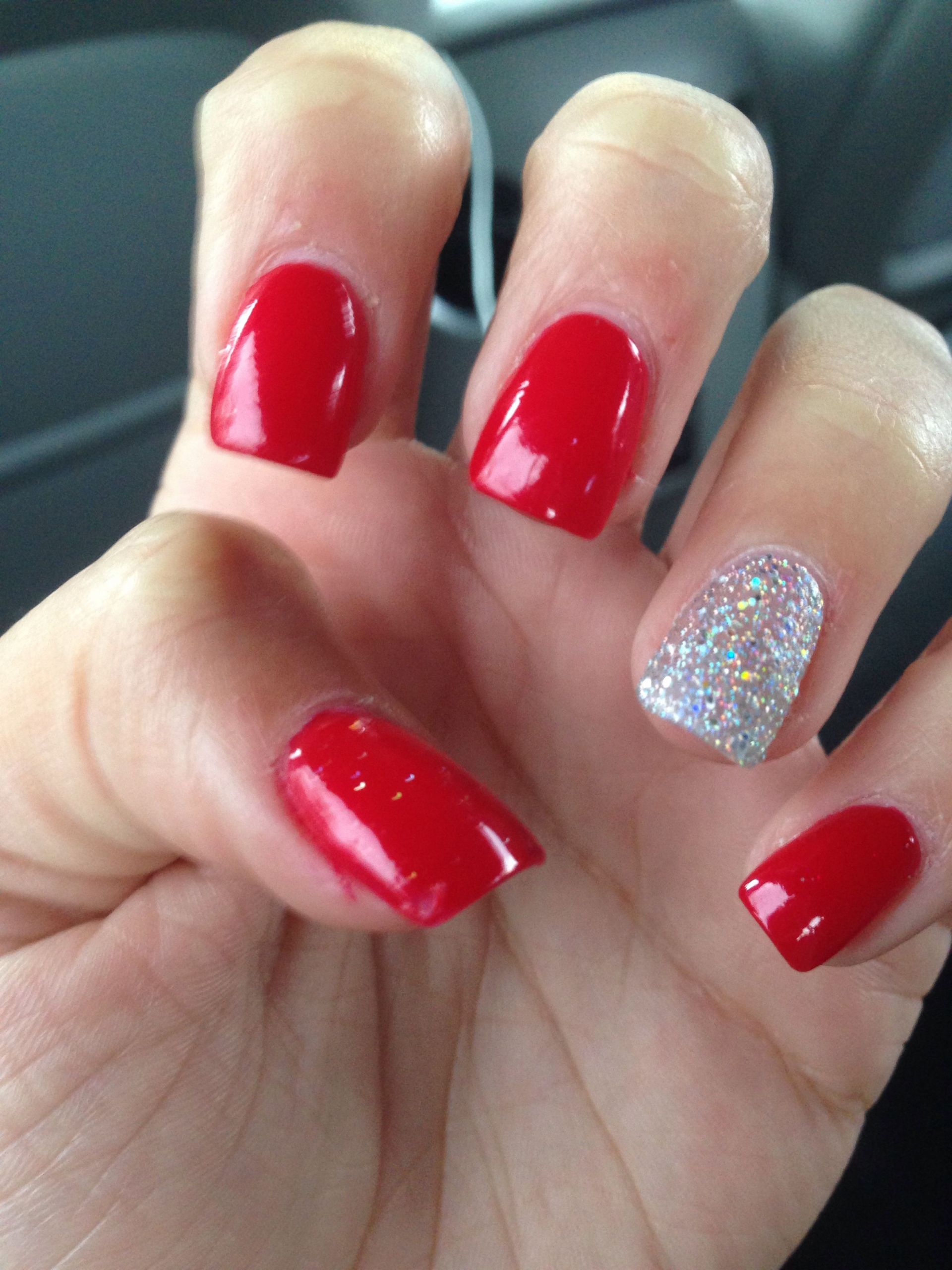 Red Nails With Glitter
 Acrylics Red with glitter nail on ring finger