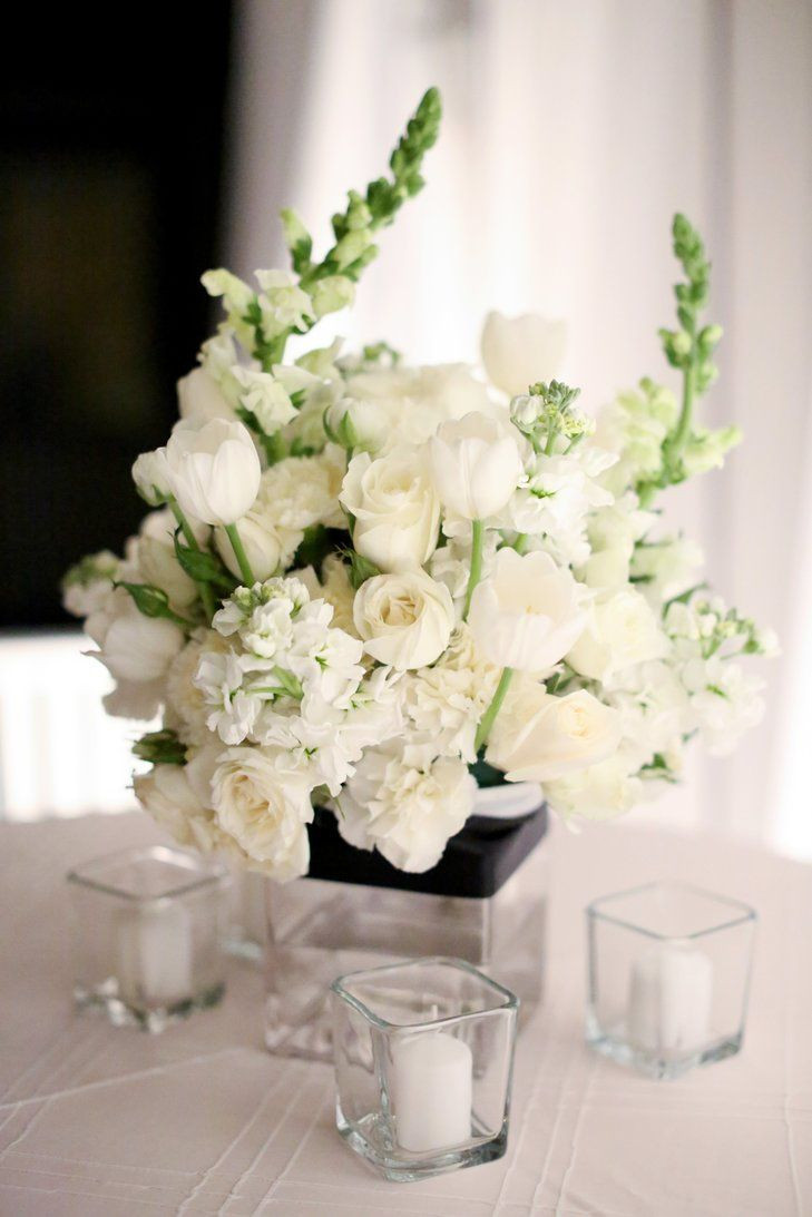 White Flower Wedding Centerpieces
 All white centerpieces of tulips roses carnations and