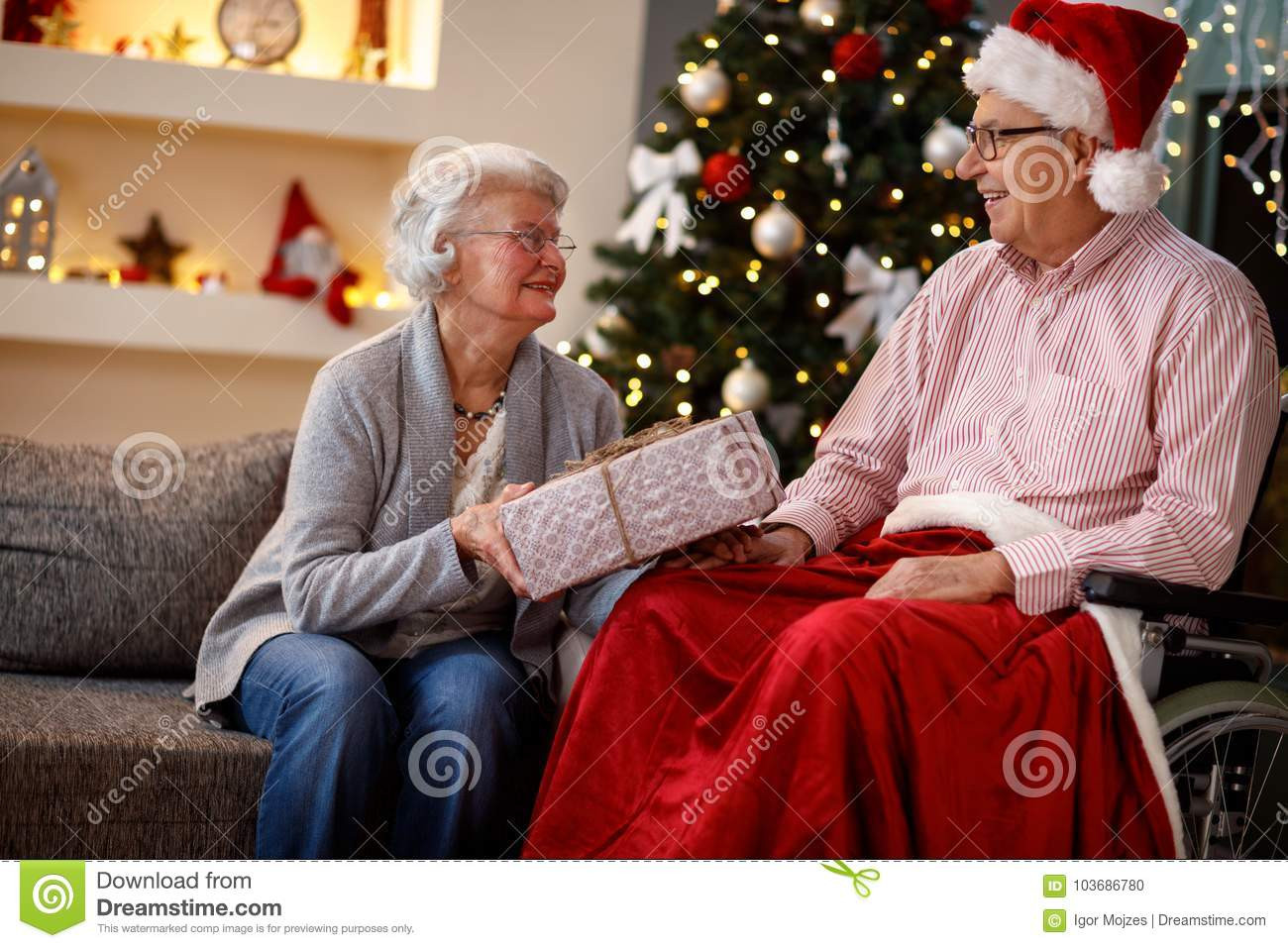 Christmas Gift Ideas For Older Couples
 Senior Couple At Christmas Sharing Christmas Gifts Stock